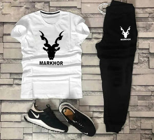 White t-shirt and black pants with 'Markhor' branding on a stone wall background